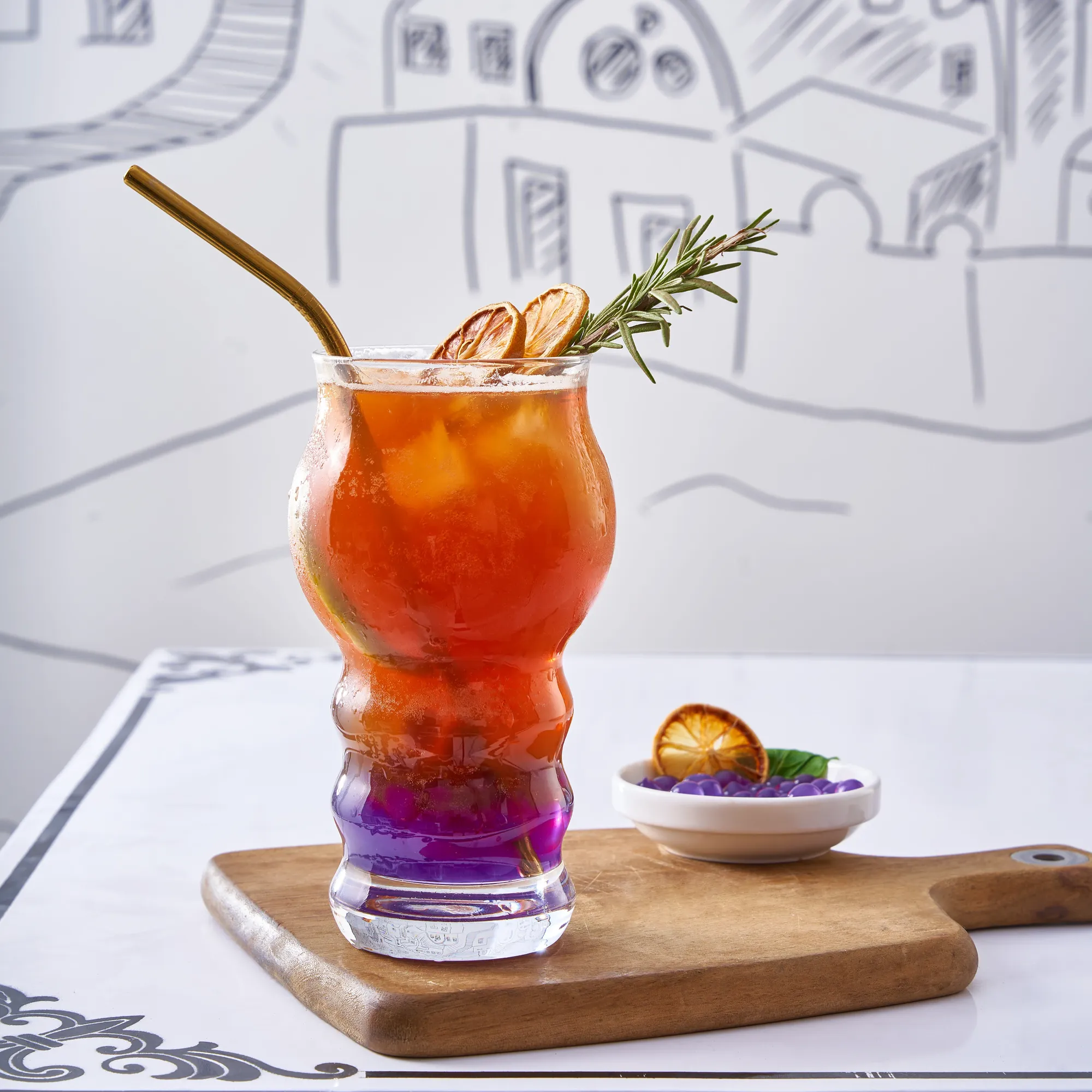 A layered iced tea with orange and rosemary