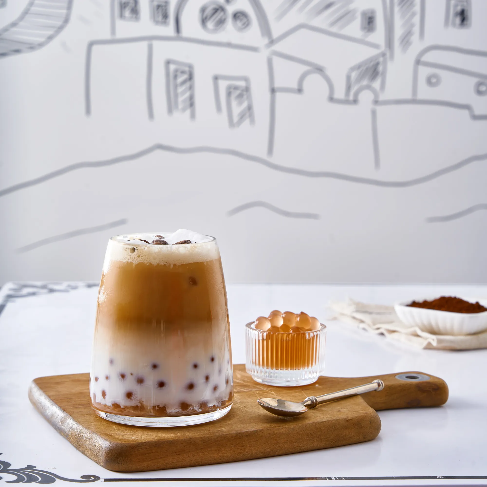 An iced bubble latte on a wooden board