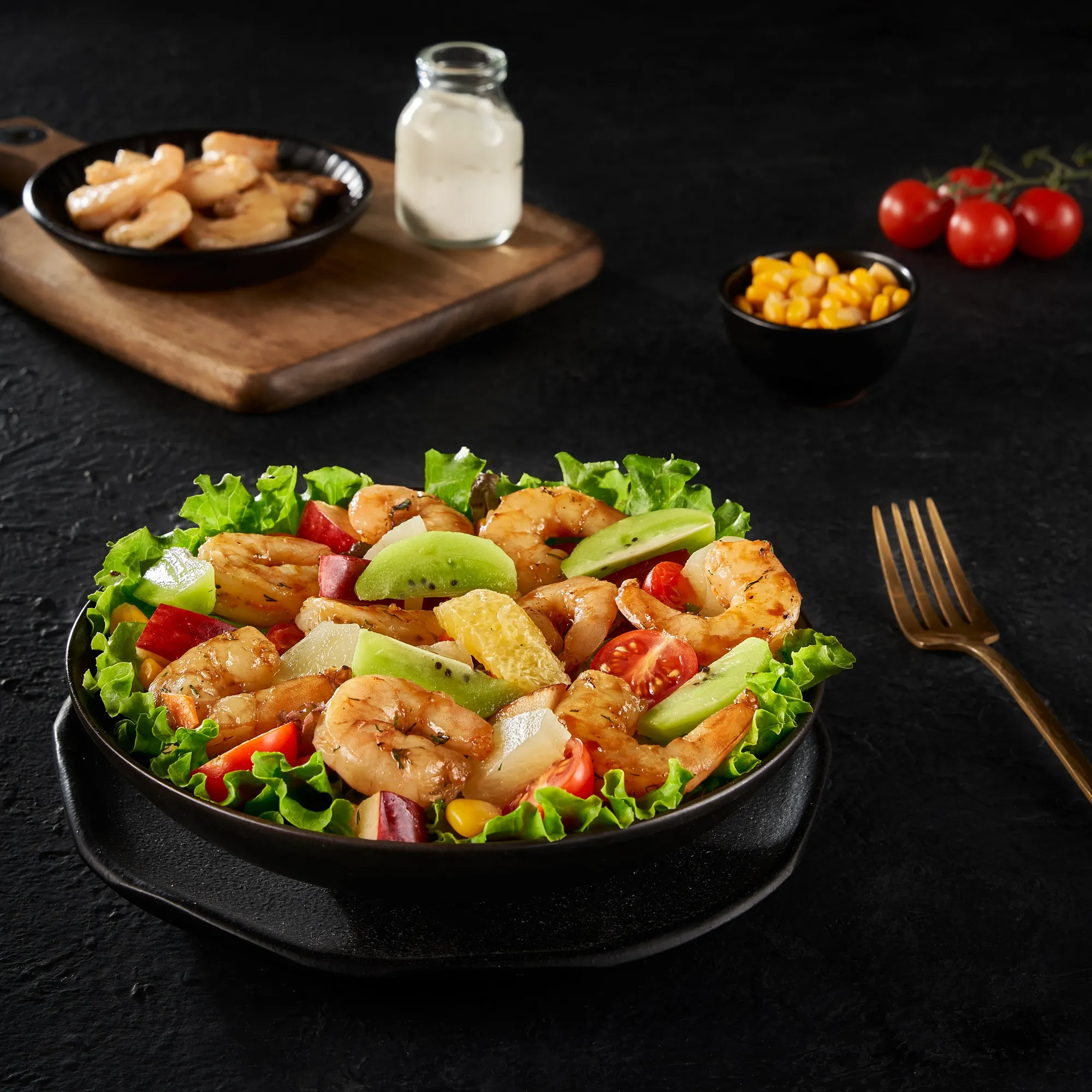 A shrimp salad on a dark table