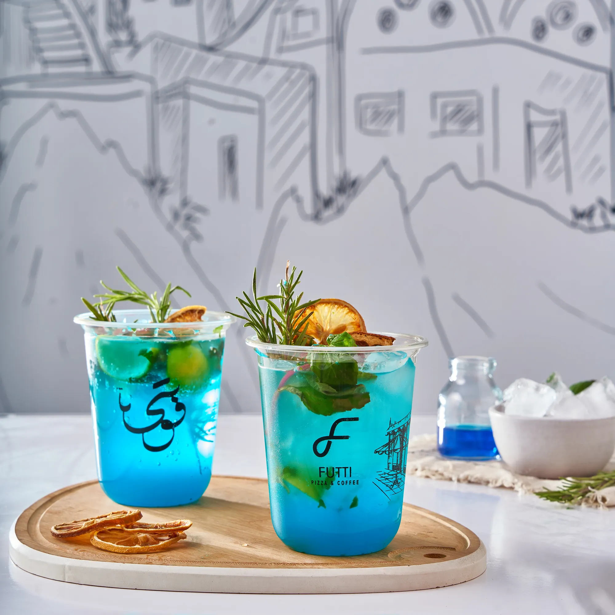 Two blue mojitos with orange slices